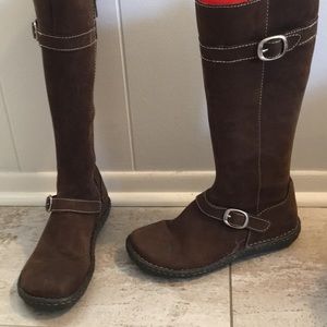 Brown leather/ suede boots with buckles/stitching.